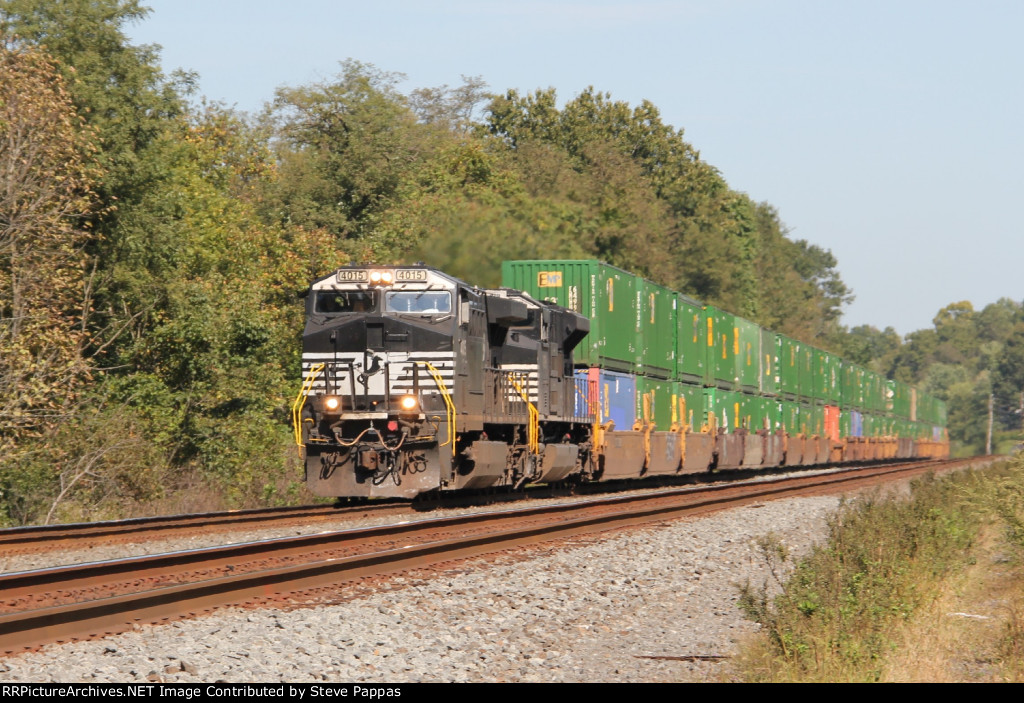 NS 4015 takes a train past MP 143.5